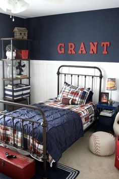 Amy of My Life From Home paired a crisp white board and batten wainscoting with deep navy walls and red accents. It's the perfect foundation for this boy's room, layered with vintage accessories, while keeping it youthful. I love the red toolbox turned toy chest. See more at My Life From Home Vintage Sports Bedroom, Small Room Diy, Big Boy Bedrooms, Boy Bedroom Design, Living Modern, Themed Bedroom, Sports Room, Boys Bedroom Decor