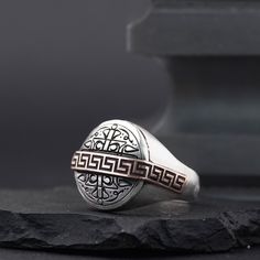 Introducing an exquisitely crafted 925 sterling silver ring, with a circular matte design and rich historical significance. The top of the ring showcases the seal of Sultan Selim I, reading "Sultan Selim Şâh, Tevekkeltü alâ Hâlıkî", translating to "I put my trust in my Creator". The ring's center is adorned with a patterned bronze strip, creating a captivating contrast and depth. This piece embodies a fusion of history, faith, and artistry, making it a meaningful gift for history enthusiasts and Sterling Silver Signet Ring With Intaglio, Silver Elegant Intaglio Signet Ring, Silver Engraved Intaglio Ring, Silver Signet Ring With Intaglio, Silver Round Signet Ring With Intaglio, Silver Signet Ring With Intaglio As Gift, Sterling Silver Signet Ring With Intricate Design, Silver Engraved Ring With Intaglio, Elegant Silver Signet Ring With Intaglio