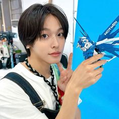 a young man holding up a model airplane