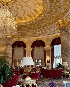 an ornately decorated room with chandeliers and couches