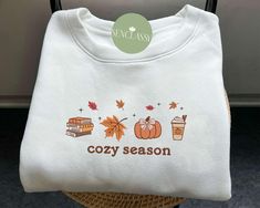 Cozy Season Fall Leaves Embroidered Sweatshirt, Spooky Fall Hoodie, Coquette Pumpkin Spice Shirt, Fall Sweatshirts For Women, Thanksgiving This sweatshirt is crafted from high-quality cotton weave and features advanced embroidery technology to ensure vibrant colors and intricate patterns. It's unisex, soft, and comfortable, making it perfect for a stylish, casual look. Each sweatshirt boasts a unique aesthetic, making it a timeless gift for family, friends, or teachers. Size: We offer a range of Cricut Sweaters, Fall Sweatshirt Ideas, Coquette Pumpkin, Embroidering Machine, Advanced Embroidery, Pumpkin Spice Shirt, Spooky Fall, Fall Shirts Women, Sweatshirts For Women