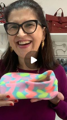 a woman holding up a colorful bag in her hands with the caption, how to make an eyeglass case