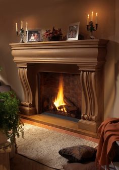 a living room with a fire place and pictures on the mantle