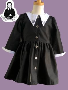 Black Cotton Dress For Costume Party, Black Cotton Costume Dress, Fitted Cotton Costume Dress, Cotton Short Sleeve Dress For Costume Party, Long Sleeve Cotton Dress For Costume Party, Cotton Fitted Dress With Peter Pan Collar, Cotton Fitted Dress With Doll Collar, Cotton Dress With Peter Pan Collar And Buttons, Bowie Dress