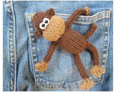 there is a stuffed monkey in the pocket of someone's jean pants that has it's eyes wide open