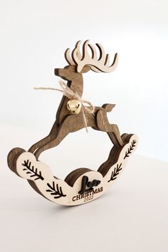 a wooden reindeer ornament with bells on it's antlers is shown