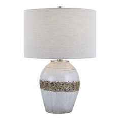 a white and gold table lamp with a beige shade