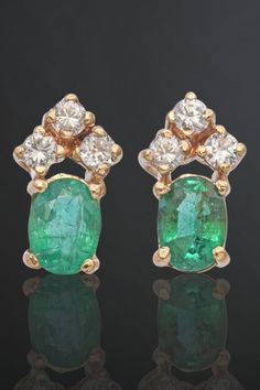 Add a splash of elegance to your style with these 14K yellow gold earrings. The 0.72 TCW oval emerald is beautifully set in a cluster of diamonds, offering a perfect blend of luxury and charm. Ideal for any special occasion or to elevate your everyday look. #GoldEarrings #EmeraldJewelry #DiamondCluster Emerald Stud Earrings, Emerald Earrings Studs, Yellow Gold Earrings, Round Stud Earrings, Diamond Stud Earrings, Trendy Earrings, Emerald Jewelry, Yellow Gold Earring, Diamond Stud