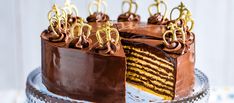 a cake with chocolate frosting and gold decorations