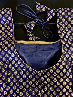 Pure Banarasi Blue Color Blouse with small Gold Buttis in Zari Weaving. Comes with Cups attached to the blouse. Please note : Blouses has margin to open 2 sizes up. Item : Ready to Wear BlouseSize : 36 (margin to open size- 40)Color : BlueSleeves : Sleevesless (Does not come with Sleeves)Blouse Fabric : Pure Banarasi SilkBlouse Fitting : Princess Cut Lining : Yes, it is fully lined Padded or Non-Padded : Padded Closure: Back Closure with hooks.Ready-to-Wear : Yes Disclaimer -This is a Standard S Transitional Blue Blouse With Zari Work, Transitional Wedding Blue Blouse, Blue Blouse With Zari Work For Transitional Season, Blue Festive Blouse Piece For Transitional Season, Blue Embroidered Blouse For Festive Occasions, Festive Blue Embroidered Blouse, Festive Embroidered Blue Blouse, Fitted Royal Blue Traditional Wear With Self Design, Blue Anarkali Top With Embroidery