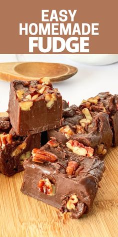 chocolate fudge bars stacked on top of each other with pecans in the background