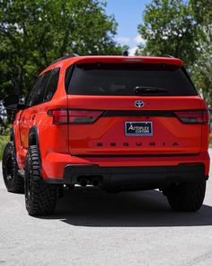 the rear end of an orange toyota rav