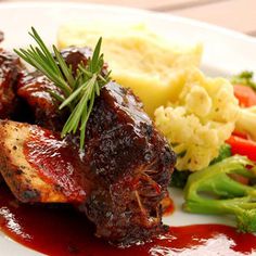 a white plate topped with meat and veggies