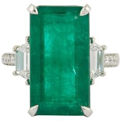 A Fabulous and Unique Green Emerald Ring!! 10.45 carat green emerald cut in a stunning elongated rectangular shape. 1.06 carats of round and special cut side diamonds all set in platinum. The ring is currently a size 6 but can easily be sized to any finger size. Antique Cocktail Ring, Green Emerald Ring, Emerald Diamond Ring, Detailed Jewelry, Bypass Ring, Colombian Emeralds, Emerald Jewelry, Platinum Ring, Three Stone Rings