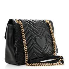 This is an authentic GUCCI Calfskin Matelasse Medium GG Marmont Shoulder Bag in Black. This shoulder bag is crafted of quilted calfskin leather in black. The bag features aged gold chainlink shoulder straps with black leather shoulder pads and an aged gold Gucci GG logo on the front. The crossover flap opens with a concealed press lock to a beige suede interior with zipper and flat pockets. Gg Logo, Gg Marmont, Shoulder Bag Black, Shoulder Pads, Chain Link, Crossover, Shoulder Straps, Calf Skin, Black Leather