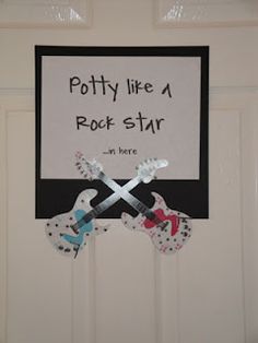 a sign that says potty like a rock star and two guitars on the front door