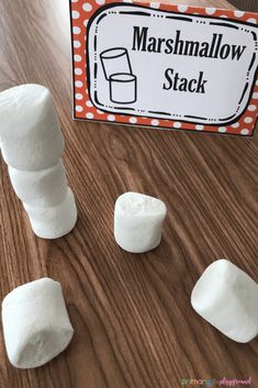 marshmallows stacked on top of each other in front of a sign that says marshmallow stack