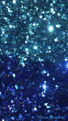 an image of blue glitter in the air with bright lights on it's side