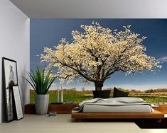 a bedroom with a large tree in the middle