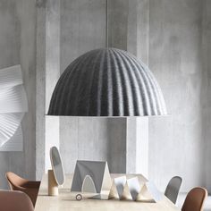 a table with chairs and a lamp in the background