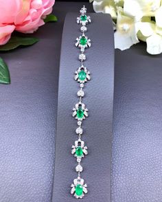 A DREAM COMES TRUE! Gorgeous masterpiece! ONE OF A KIND Bracelet! Featuring 6 pieces of extra fine GLOWING BRIGHT GREEN Zambian Emerald weighting a total of 4.05 carats... and OVER 138 pieces of SPARKLING, top-grade, F/VS Diamonds (2.28 carat in total). SET IN ONE-OF-A-KIND 18K Solid White Gold, meticulously designed and handcrafted BRACELET! A true heirloom piece that can transcend beyond times and eras.... EMERALDS: Weight: 6 pieces 4.05 carats (about 0.7 carat each) Shape: OVAL CUT Dimensions Luxury Silver Tennis Bracelet With Emeralds, Silver Emerald Tennis Bracelet For Formal Occasions, Elegant Silver Tennis Bracelet With Emeralds, Elegant Silver Emerald Tennis Bracelet, Formal Silver Tennis Bracelet With Emeralds, Formal Silver Emerald Tennis Bracelet, Formal Silver Diamond Bracelet With Emeralds, Art Deco White Gold Diamond Bracelet Gift, Emerald Tennis Bracelet With 17 Jewels For Wedding