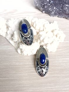 Lapis Lazuli Silver earrings for women. The blue color makes these silver earrings look more beautiful and effective. 【FULL DETAILS】 ▶Gemstone: Lapis Lazuli ▶Stone Size: 14 * 9 mm ▶RING SIZE: Adjustable ▶RING WEIGHT: 13.4 gr ▶EARRINGS WEIGHT: 24 gr ▶EARRINGS LENGTH: 40 mm ▶EARRINGS WIDTH: 19 mm For the same jewelry with red color zircon, click here: https://etsy.me/2OE9EId With purple zircon, click here: https://etsy.me/2CKsLO8 With Variscite Gemstones, click here https://etsy.me/2OzPTSk With La Unique Blue Earrings Stamped 925, Silver Lapis Lazuli Round Earrings, Silver Round Lapis Lazuli Earrings, Silver Lapis Lazuli Pierced Earrings, Silver Lapis Lazuli Gemstone Earrings, Silver Lapis Lazuli Drop Earrings, Elegant Silver Lapis Lazuli Earrings, Elegant Silver Earrings With Lapis Lazuli, Black Obsidian Jewelry