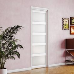 an empty room with pink walls and a potted plant