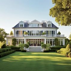 a large white house surrounded by hedges and trees