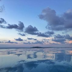 the reflection of clouds in the water is very clear and blue at sunset or dawn