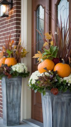 two metal planters filled with pumpkins and flowers