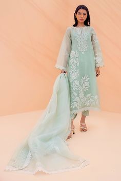 This mint organza shirt exudes understated elegance. Thoughtfully crafted using a variety of techniques, it is detailed with a scallop border and floral embroidery. Complete the outfit with our signature SM cropped raw silk trousers for a simple yet striking look. Pakistani Organza Suits, Organza Suits Indian, Eid Collection 2022, Simple Indian Suits, Organza Suit, Sania Maskatiya, Organza Suits, Scallop Border, Organza Shirt