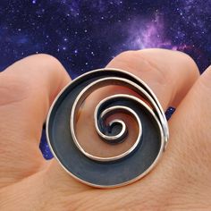 A bold & unique design to invite the significance of spirals into your day-to-day. Spirals represent the journey and change of life as it unfolds. They are a powerful symbol that have been used in ancient cultures around the world since prehistory in order to represent expansive, cosmic wisdom and the universal pattern of growth and evolution, eternity and continuity.Wearing spiral jewelry brings the presence of this prehistoric symbol into daily life, inviting oneself to explore the infinity of Modern Jewelry With Unique Spiral Design, Spiral Ring With Unique Design, Luxury Unique Spiral Jewelry, Modern Gold Spiral Ring, Unique Spiral Metal Rings, Change Of Life, Academia Jewelry, Dark Academia Jewelry, Cosmic Universe