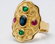 Gold Multi-stone Oval Sapphire Ring, Gold Multi-stone Sapphire Ring With Oval Shape, Gold Oval Sapphire Ring With Multi-stones, Oval Gold Emerald Ring With Stone Setting, Byzantine Style Oval Gemstone Jewelry, Byzantine Oval Gemstone Jewelry, Gold Multi-stone Oval Cabochon Ring, Byzantine Style Gemstone Rings For Gifts, Byzantine Gemstone Ring As Gift