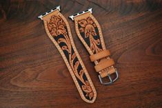 This is a 100% hand tooled watch strap with Sheridan style tooling, done on the highest quality natural veg tan in the US. This style of tooling is a traditional western art typically done during saddle making. hand dyed background to make the design stand out. Lined with soft, natural veg tan pigskin. Add some traditional leatherwork to your modern Apple Watch. -This strap is 22mm at the adapters, swells to around an inch or 3cm and tapers to an 18mm buckle. -Made to the standard watch strap size; 120mm point side and 80mm buckle side. If you would like custom sizing, please contact me, it should not be a problem. Please note that since the tooling is hand done, patterns may slightly vary from strap to strap. Tooled Leather Watch Bands, Vintage Hand Tooled Adjustable Watch Bands, Vintage Adjustable Hand Tooled Watch Bands, Leather Design Pattern, Saddle Making, Apple Watch Armband, Apple Watch Leather Strap, Design Stand, Hand Tooled Leather