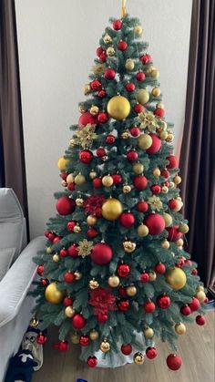 a decorated christmas tree with red and gold ornaments