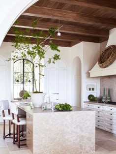 a kitchen with white cabinets and an island