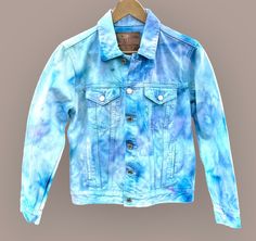 Handmade  item  Hand dyed, Ice Dye technique  This BLUES PAL denim jacket has shades of lavender and several shades of blue. Very lovely watercolor, feminine design.  100% cotton  Lucky Brand, The Tomboy Trucker denim jacket.  Women's size Medium  All measurements taken with garment laid flat.  Chest-19 inches  Bottom hem-18 inches  Sleeve-22 inches  Length from shoulder-22 inches  Professional procion dyes. Will remain vibrant. Will not bleed in wash.  Machine wash cold, hang to dry.  Since dis Tie Dye Jean Jacket, Dye Denim, Dyed Denim, Tie Dye Women, Tie Dye Denim, Ice Dye, Ice Dyeing, Purple Ombre, Feminine Design