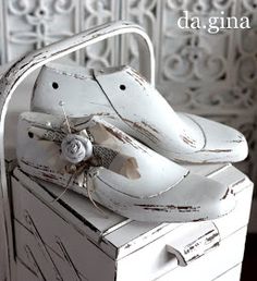 an old pair of white shoes is sitting on top of a box that says da gina