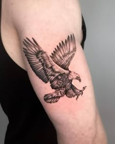 an eagle tattoo on the arm and shoulder