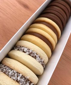 a white box filled with lots of different types of cookies