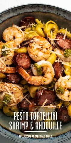 a bowl filled with shrimp and veggies on top of a table