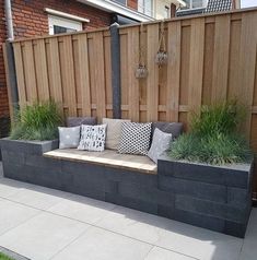 a bench made out of cinder blocks with pillows on it