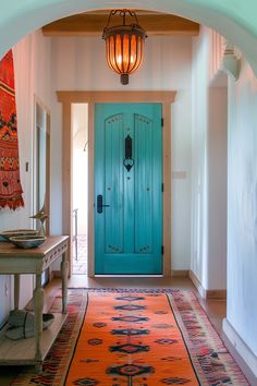 a blue door is in the middle of a hallway with an orange rug on the floor