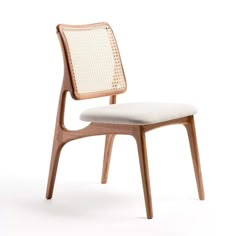 a wooden chair with white upholstered fabric on the back and seat, against a white background