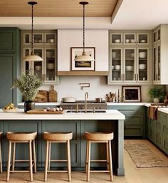 an image of a kitchen setting with green cabinets and stools on the countertop