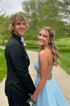 a young man and woman dressed in formal wear