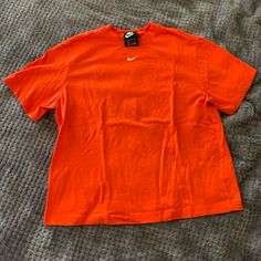 Size Small Brand New Without Tags Has Never Been Worn Excellent Condition Nike Casual Solid Color T-shirt, Nike Casual Solid T-shirt, Casual Solid Nike T-shirt, Casual Solid Color Nike T-shirt, Casual Nike T-shirt, Nike Orange Crew Neck T-shirt, Basic Orange Tops For Streetwear, Nike Casual Orange Tops, Orange Sporty T-shirt For Spring