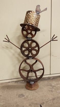 a metal snowman with a hat on top of it