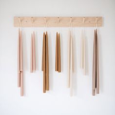 several different colored sticks hanging on a wall