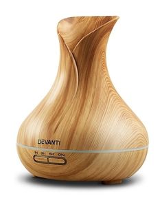 a wooden vase sitting on top of a white surface with the words devanti written in